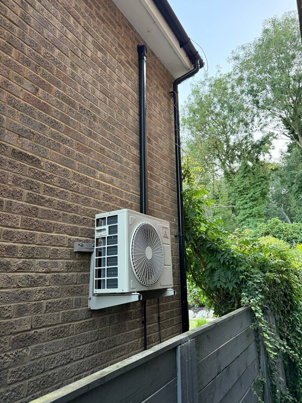 Outdoor air conditioning condenser with tidy pipework